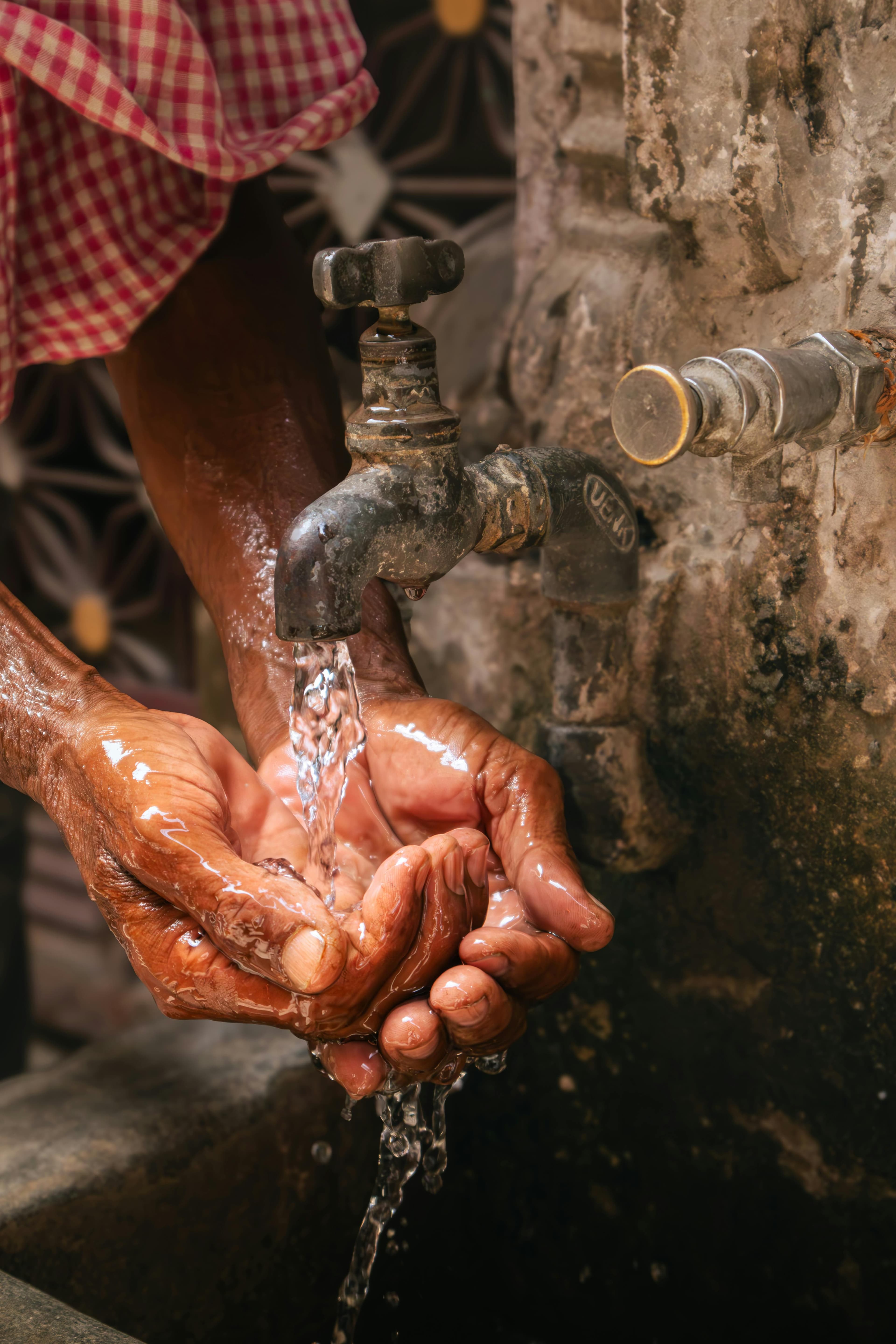 Rural community collecting water from distant source